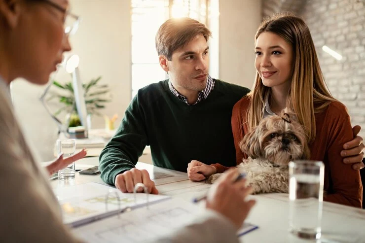 smiling couple with dog talking their insurance agent meeting office 637285 2832